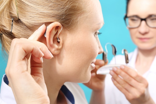 woman trying on hearing aid