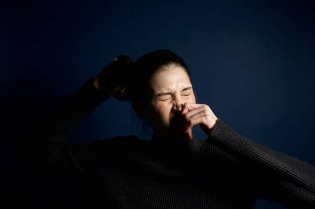 Woman sneezing 