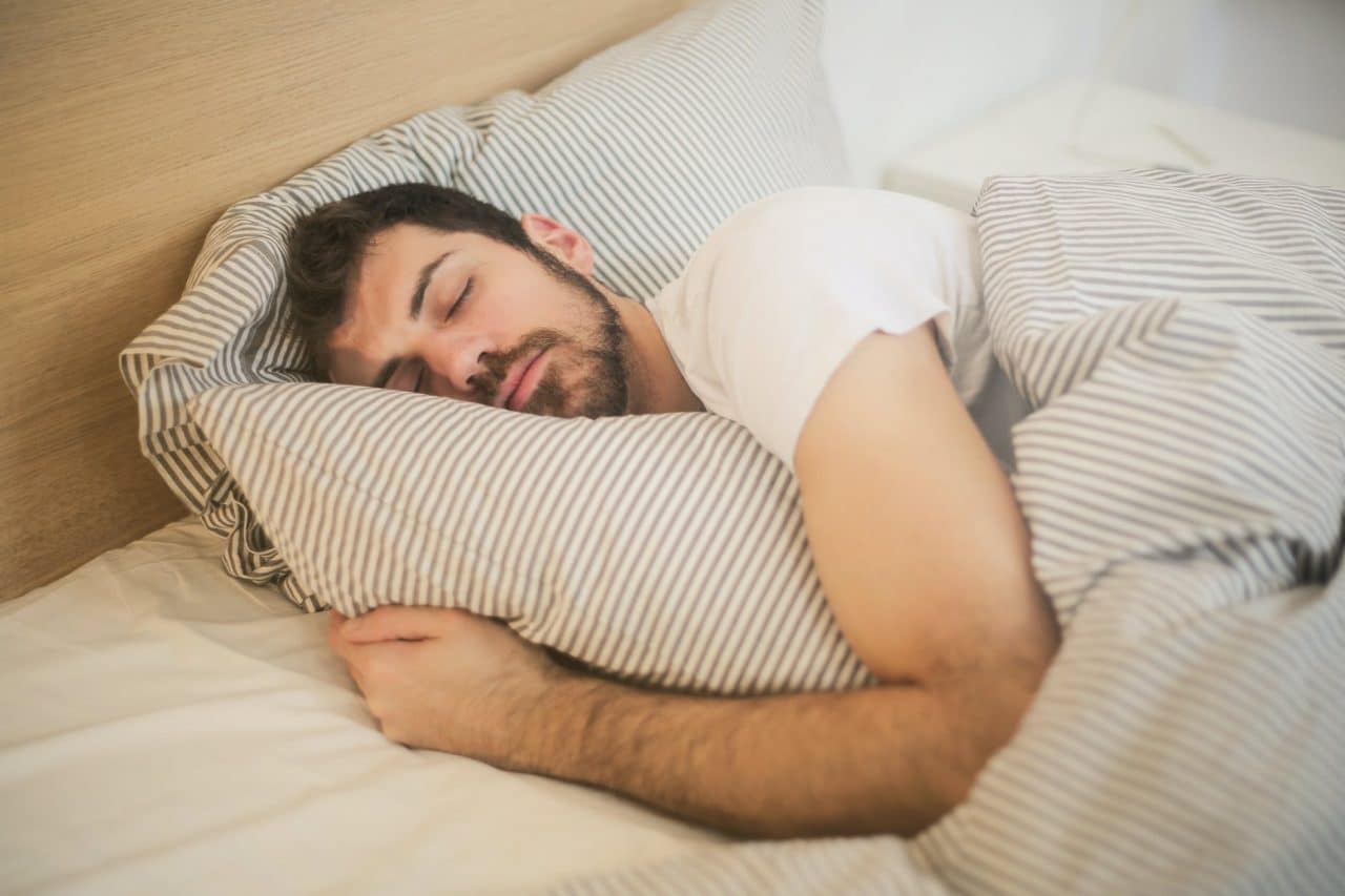 Man sleeping in bed.