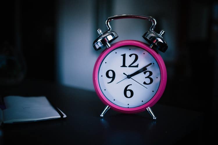 An alarm clock on a nightstand.