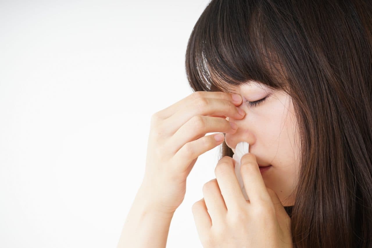 Woman getting a nose bleed.