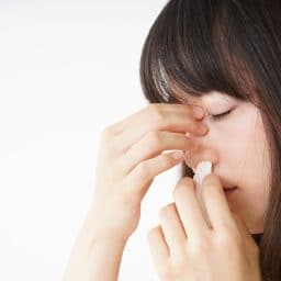 Woman getting a nose bleed.