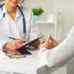 A doctor speaks with a patient about a procedure.