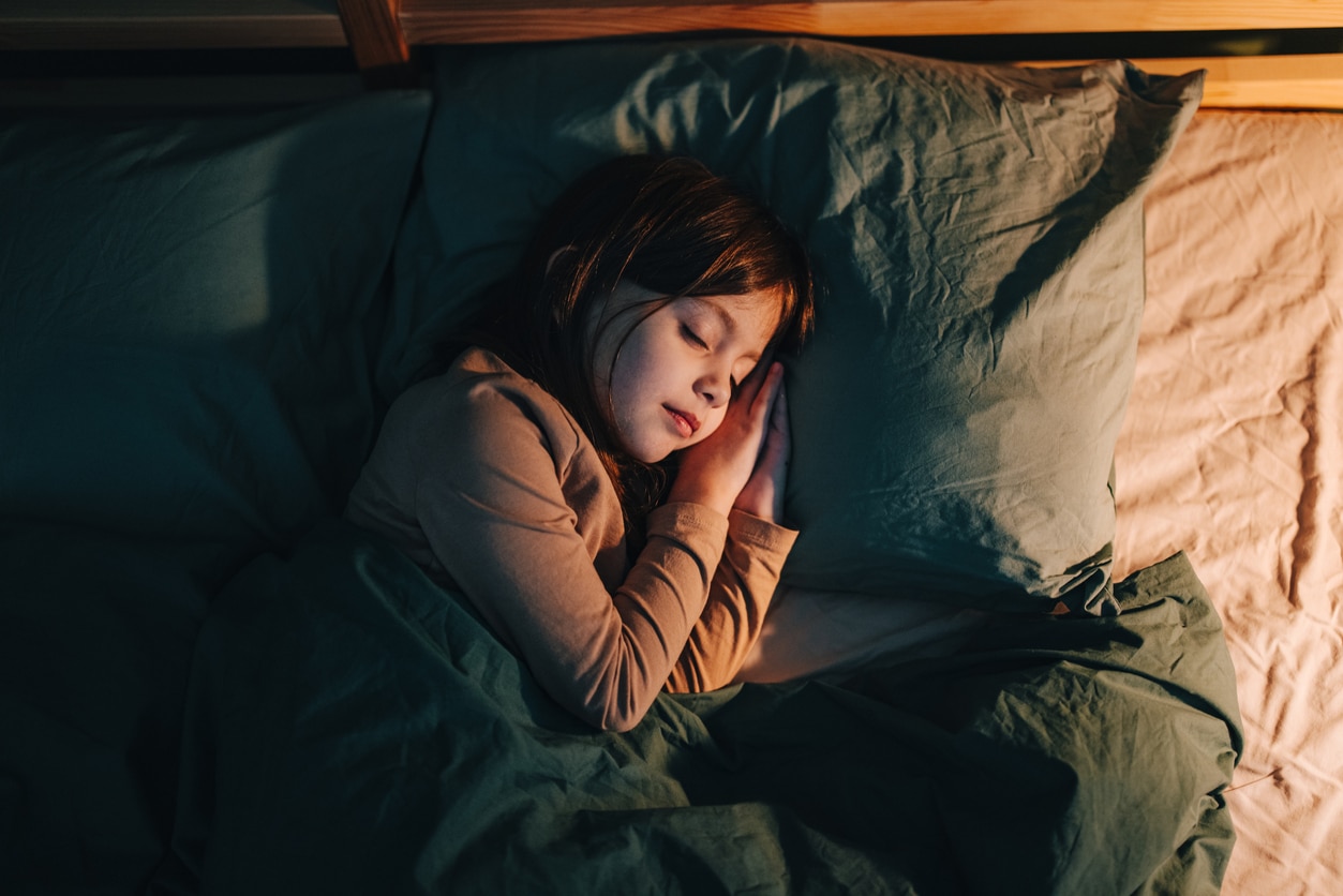 Girl sleeping in bed.