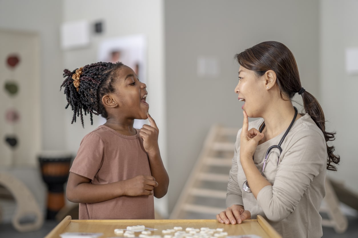 Young girl works on speech therapy