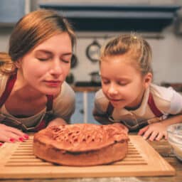 Mom and daughter smelling a freshly baked pie