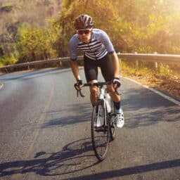 Cyclist biking up a steep hill